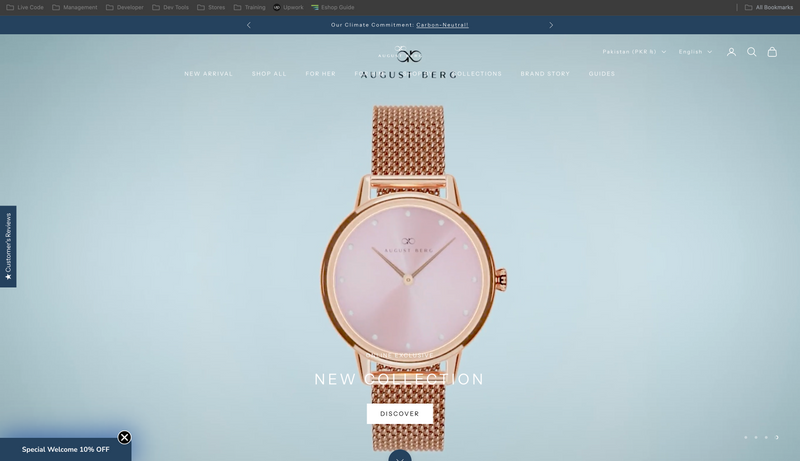 Rose gold watch with pink face on a light blue background